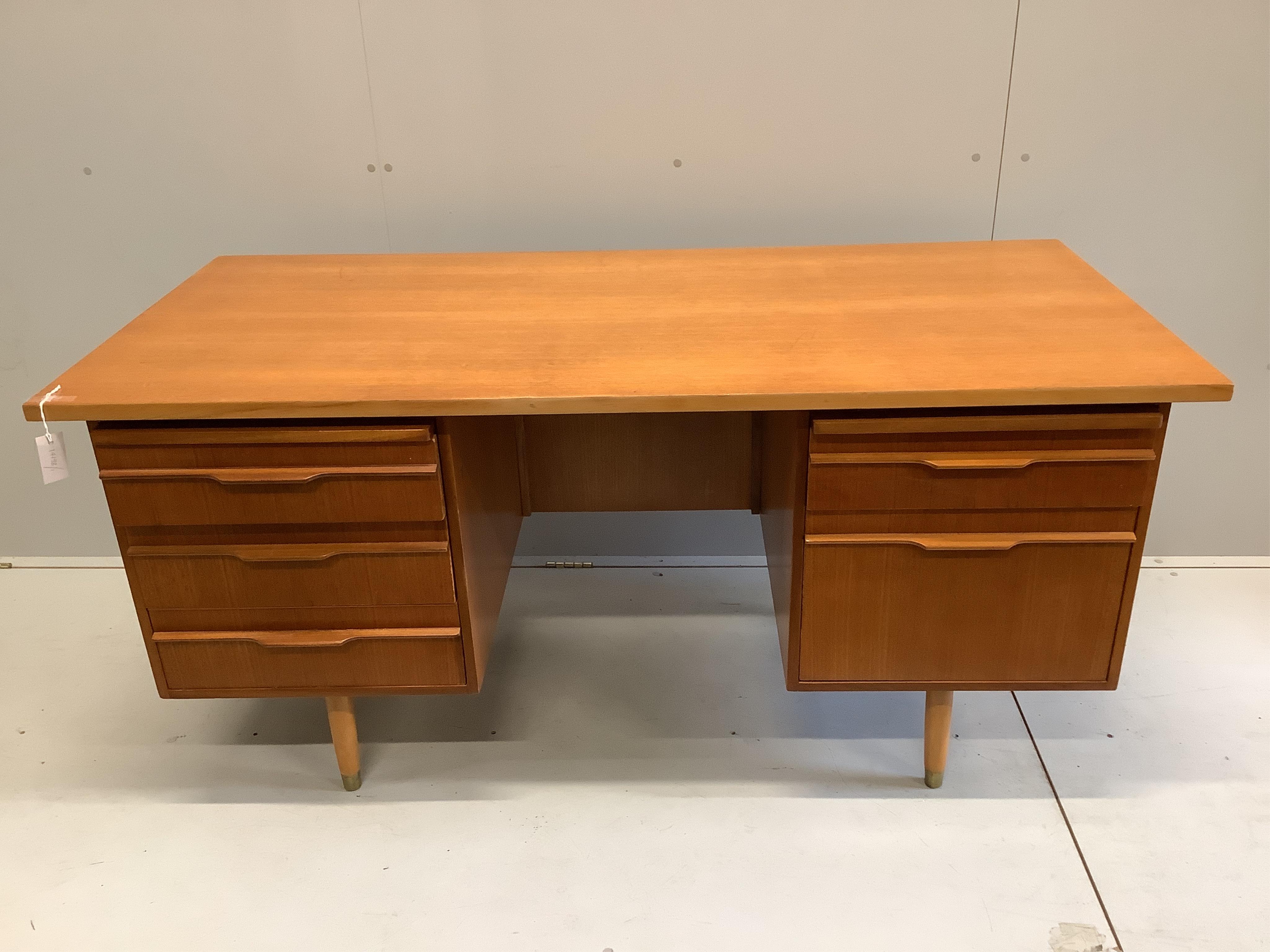 A mid century teak kneehole desk, width 160cm, depth 76cm, height 76cm